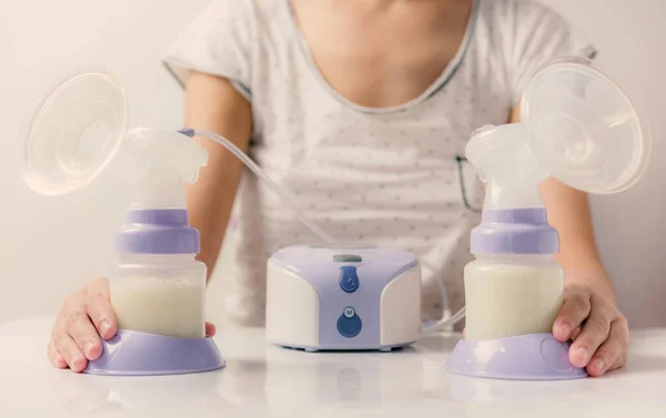 Mother holding Electric Breast Pump for Breast feeding