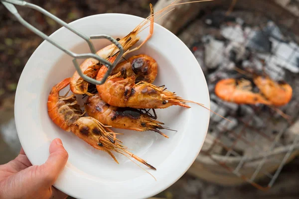 shrimp grilled bbq seafood on stove, outdoor food,  Grilled shrimp on a charcoal stove in white dish