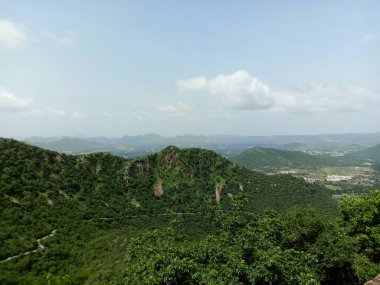 green Aravali mountain and sky  in UDAIPUR CITY RAJASTHAN in india .