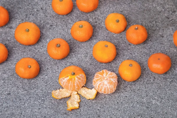Fresh Clementines fruit peeled on stone — Stock Photo, Image