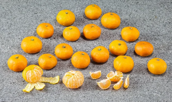 Fresh Clementines Mandarin fruit peeled on stone — Stock Photo, Image