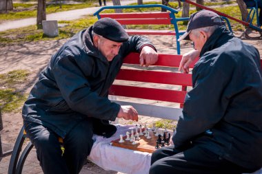 Men play chess in the park of Odesa