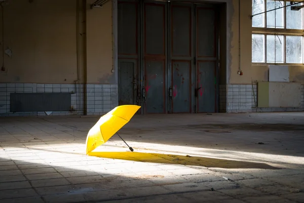 Umbrella on a factory floor — Stock Photo, Image