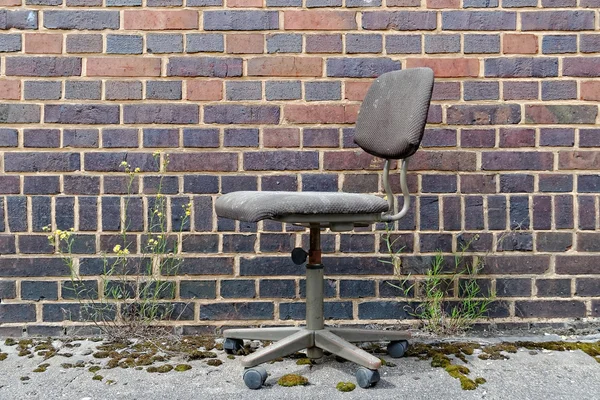 Office chair in front of brick wall — Stock Photo, Image