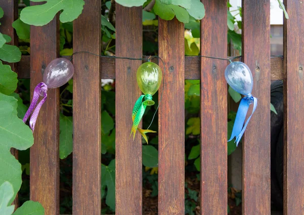 Elektryczna Girlanda Małych Kolorowych Balonów Ozdobiona Wstążkami Brązowym Drewnianym Ogrodzeniu — Zdjęcie stockowe