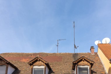 Almanya 'da mavi gökyüzü ve televizyon anteni olan ev çatıları