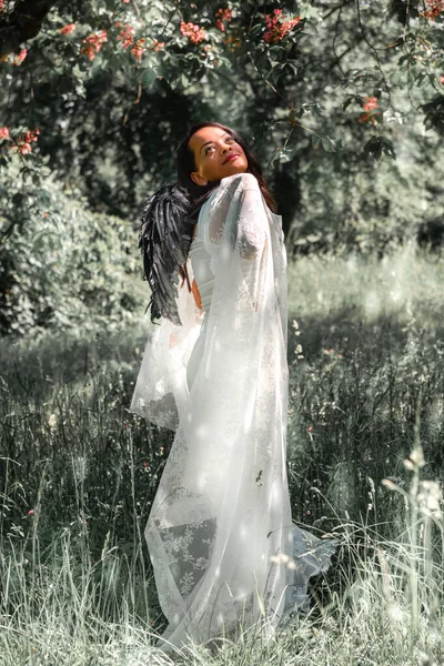 Woman White Dress Black Angel Wings Forest Flowers — Stockfoto