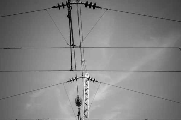 power lines from a railway line in black and white