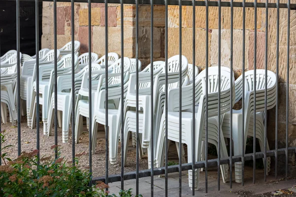 White Plastic Chairs Stacked Front Brick Wall Grid —  Fotos de Stock