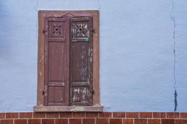 an old closed wooden window shutter with text free space right