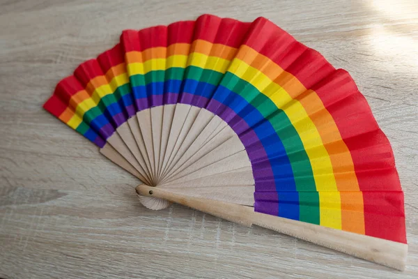 an air fan in rainbow colors made of wood