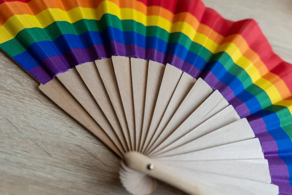 an air fan in rainbow colors made of wood