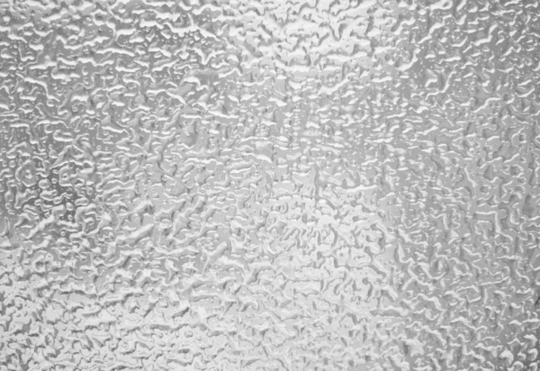 Gocce d'acqua congelate su vetro Immagine Stock