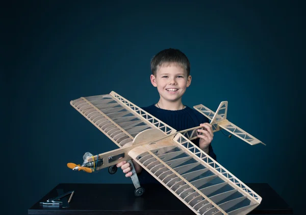 Little boy has holding the model airplane. Hobby. — Stock Photo, Image