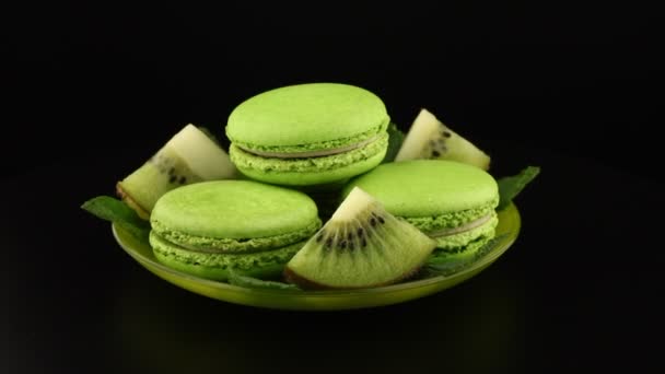 Green Macaroons Kiwi Slices Saucer Rotate Black Background — Stock Video