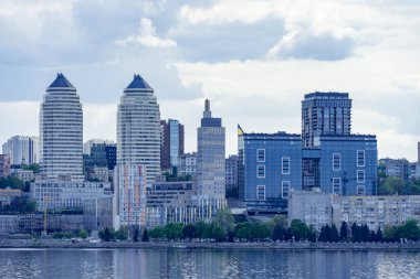 Ukrayna 'daki merkezi Dnipro şehri ve nehir kıyısında panoramik manzara. Alışveriş merkezleri, iş ofisleri ve yüksek katlı daireleri olan şehir manzarası. Gökyüzüne karşı güzel bir set. Doğu Avrupa.
