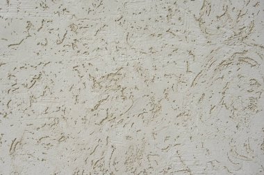 Binanın dışındaki duvarda desenler var. Yakın plan. kaotik desenler. Fotoğraf arkaplanı olarak kullanılabilir