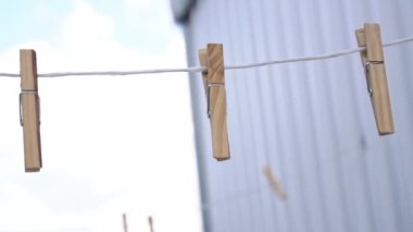 clothespins hanging from a rope after rain.  close-up