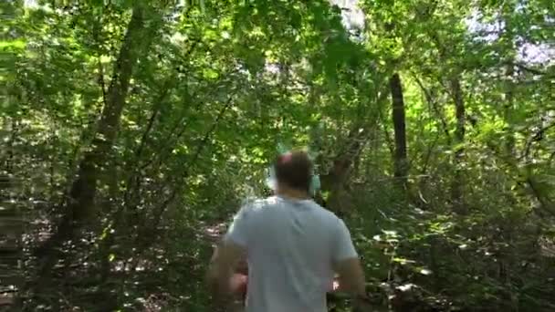 Young Man White Meek Gray Shorts Headphones Runs Forest Summer — стоковое видео