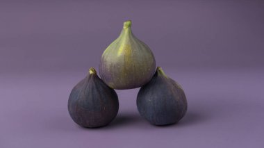 figs folded in a pyramid lies on a solid background. close-up, veri peri color
