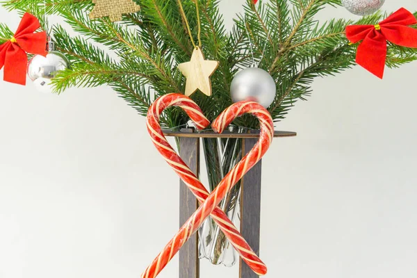Decorated spruce branches in a stand with test tubes on a white background. — Stock Photo, Image