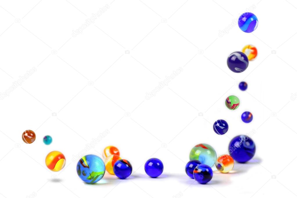 Colorful marbles floating on white background