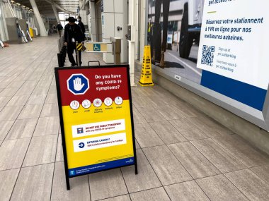 Vancouver, Canada - January 15,2022: View of sign Do you have any Covid-19 symptoms at Vancouver International Airport(YVR)