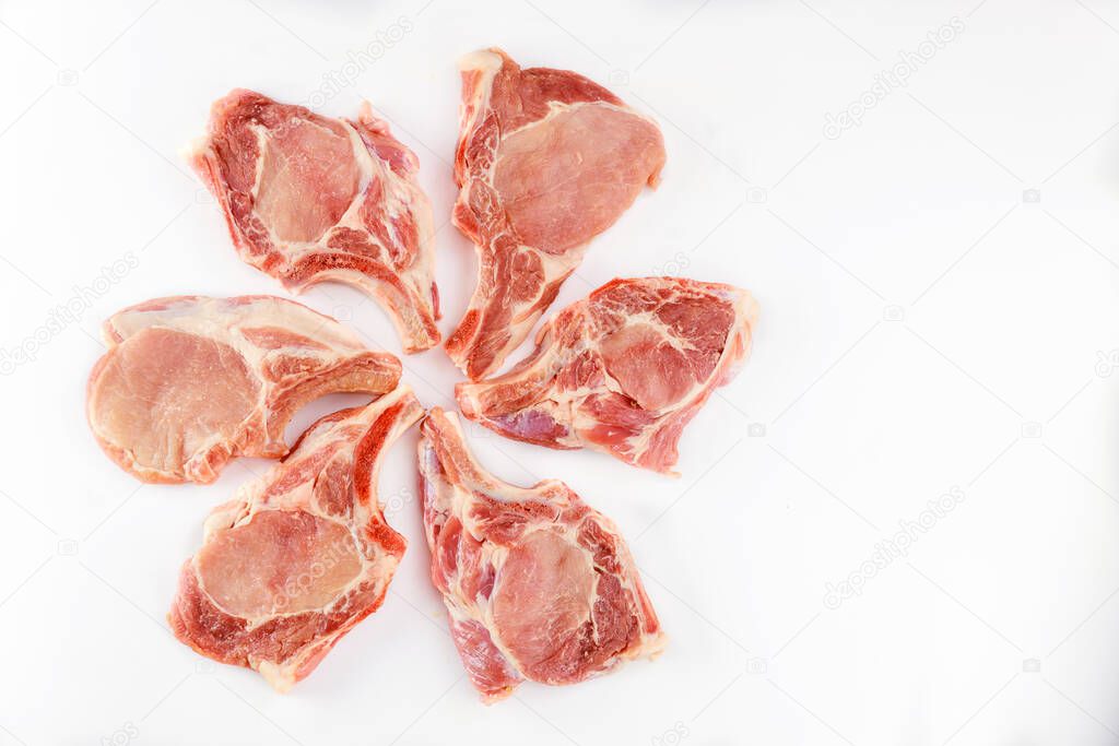Raw pork chops bone in isolated on white background. Close up.