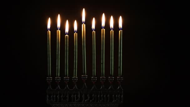 Close up of burning menorah with candles for Hanukkah in the dark. — Stock Video