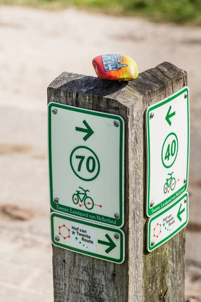 Colored boulder on cycle route sign — Stock Photo, Image