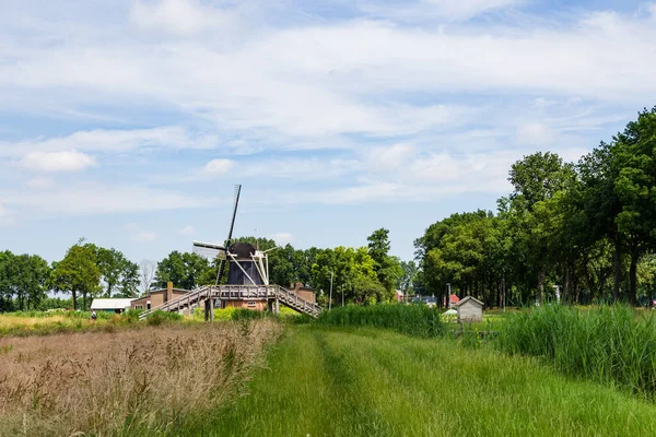 Sunny windmill and bridge landscape — Stock Photo, Image