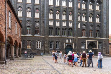 Lubeck, Germany - July 30, 2022: Guided tour groep in front of the City hall of Lubeck in Schleswig-Holstein in northern Germany