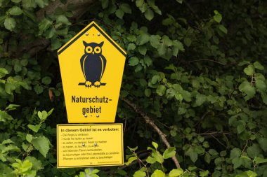 Zarrentin am Schaalsee, Germany - August 1, 2022: Nature park sign with owl allong the former internal border West and East Germany in biosphere nature park Schaalsee