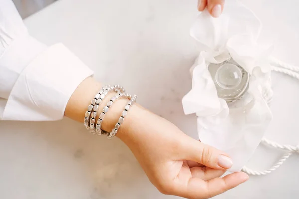 Women Hands Silver Bracelet Beautifully Open Bag Transparent Perfume White — Stock Photo, Image