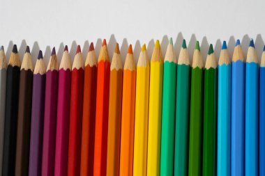 Sharpened bright pencils on white isolated background, place for text