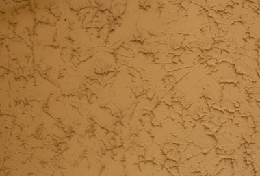 Eski, sarı kahverengi alçı sıva duvar arkaplan dokusu