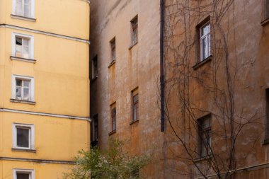 A corner of old building facade of typical houses in Odessacity center old town yards. Vintage windows, dirty scratched walls.