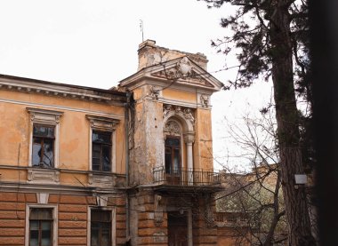 Odessa, Ukraine - 04 24 21: historical Mendeleevich manor on Marazlievskaya street 18 next to Shevchenko park. A part of old architecture monument house facade with huge windows and balconies