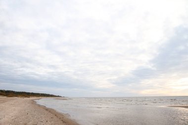 Kum ve Baltık Denizi ile güzel deniz manzarası. Fotoğraf, sıcak ve bulutlu bir sonbahar havasında çekildi..