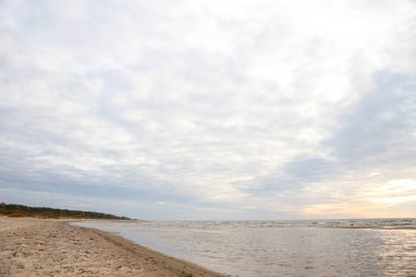 Kum ve Baltık Denizi ile güzel deniz manzarası. Fotoğraf, sıcak ve bulutlu bir sonbahar havasında çekildi..