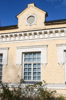 Unique architecture building from old yellow color bricks. Photo taken on a warm autumn day.