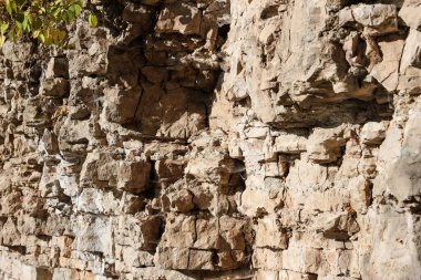 Natural view of dolomite outcrop wall in nature. Photo taken in autumn, in daylight.