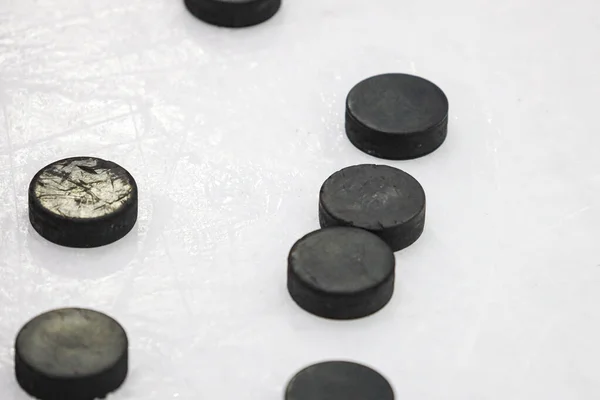 Multiple Black Ice Hockey Pucks Laying Ice Rink Ground Photo — Stock Photo, Image