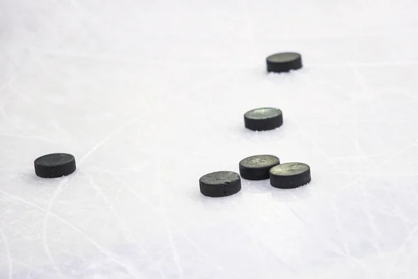 Multiple Black Ice Hockey Pucks Laying Ice Rink Ground Photo — Stock Photo, Image