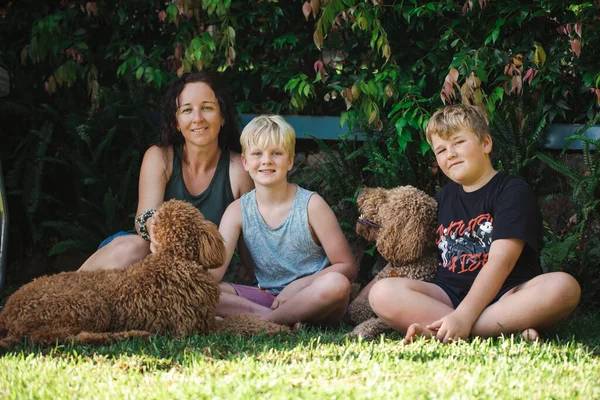 Madre Hijos Sentados Hierba Con Dos Perros Groodle —  Fotos de Stock