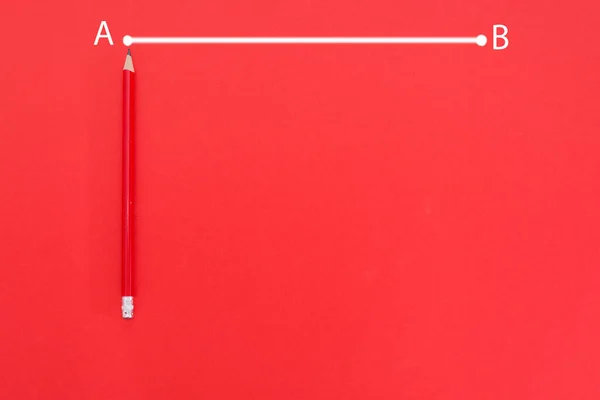 the line from point A to point B is drawn in white on a red background with red pencil and copy space.