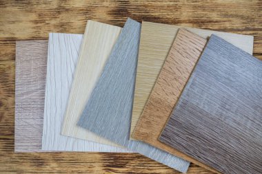wooden premium sampler for design of modern apartments.Laminate background. Samples of laminate or parquet with a pattern and wood texture for flooring and interior design. Production of wooden floors