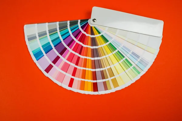 Color palette, paint swatch guide, color catalog on orange background