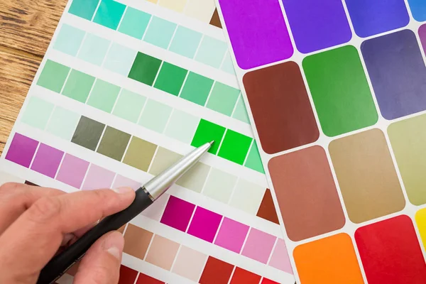Color palette, guide of paint samples, colored catalog.hand choose color in palette samples. Rainbow colors catalogue