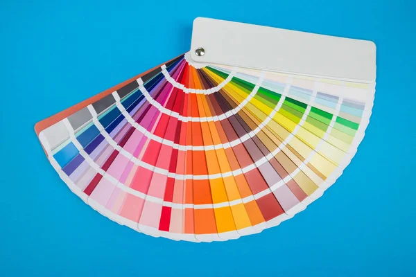 Color palette, paint swatch guide, color catalog on a blue background